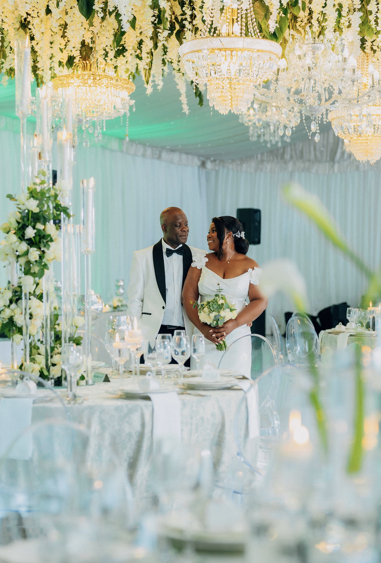 Couple at elegant reception with chandeliers